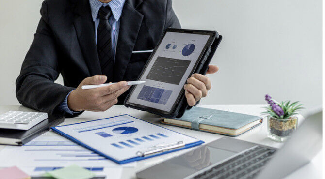 Male business person referring to data
